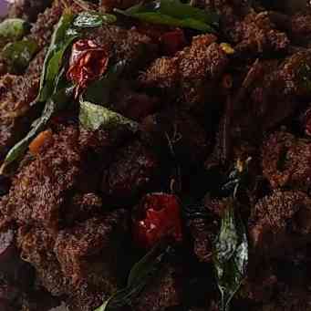 Savory beef chukka dish with tender beef chunks, aromatic spices, and a rich masala coating, presenting a flavorful and appetizing South Indian culinary delight