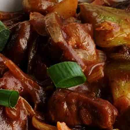 Savor the bold flavors of Beef Manchurian Dry, showcasing succulent beef, vibrant vegetables, and a tantalizing blend of sweet and savory sauces for a delightful and zesty culinary experience