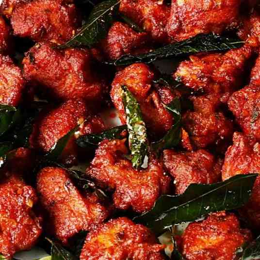 Delicious boneless chili chicken dish with succulent pieces, vibrant spices, and a tempting presentation