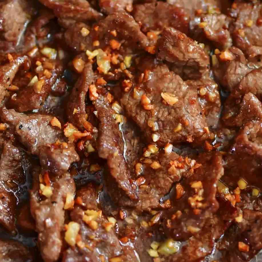 Indulge in the aromatic perfection of Garlic Beef Dry, featuring tender beef, aromatic garlic, and a rich blend of spices for a flavorful and satisfying dining experience