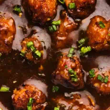 Savor the delicious fusion of flavors with Chicken Manchurian Gravy, featuring succulent chicken, vibrant vegetables, and a tantalizing blend of sweet and savory sauces for an exquisite culinary experience